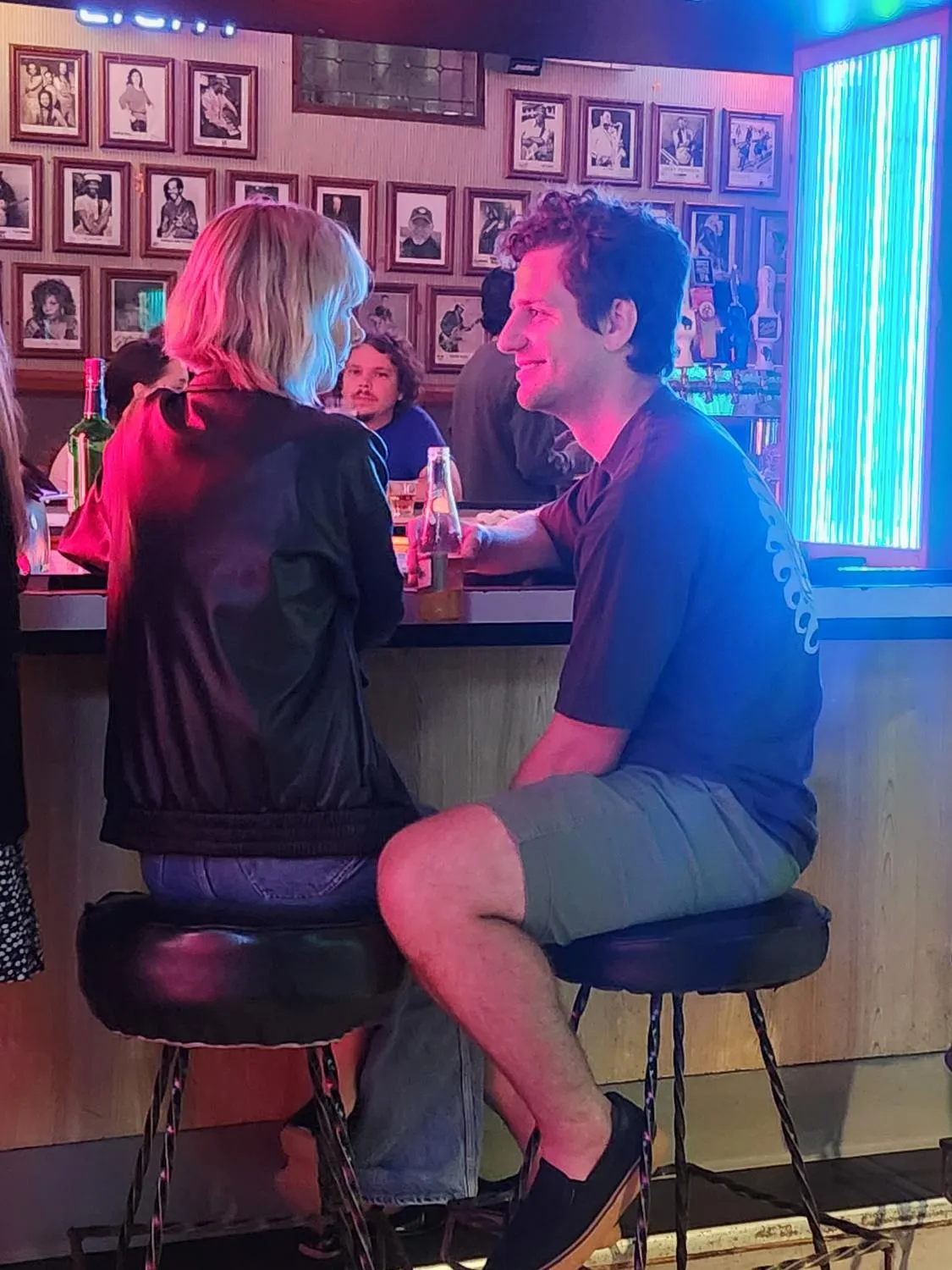 Sean and Ashley at a bar table, drinks in front of them.