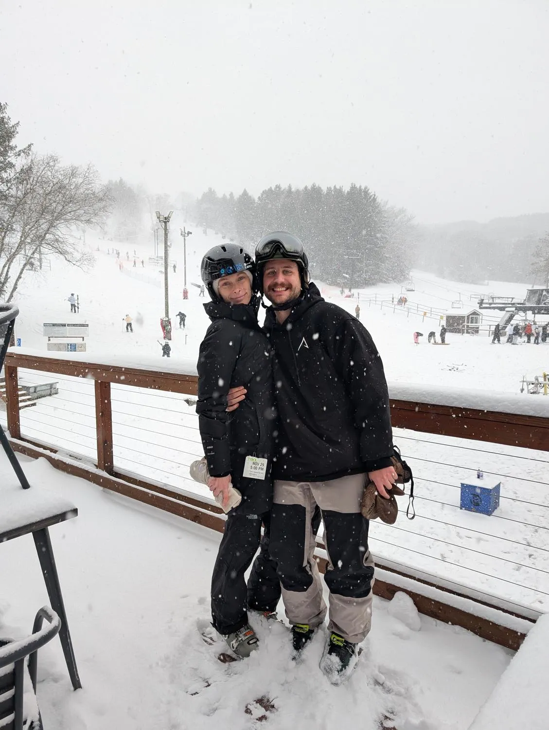 Sean and Ashley on a ski slope in full gear, snow behind them.